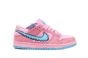 The Nike SB Dunk Low Grateful Dead SB Dunks Pink features a fuzzy pink faux-fur upper